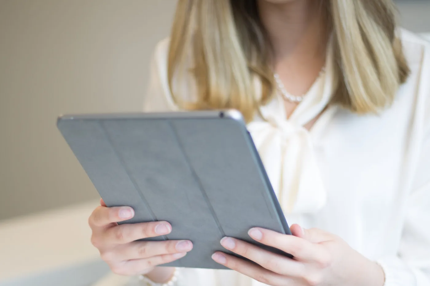 A clinician using a tablet at a desk